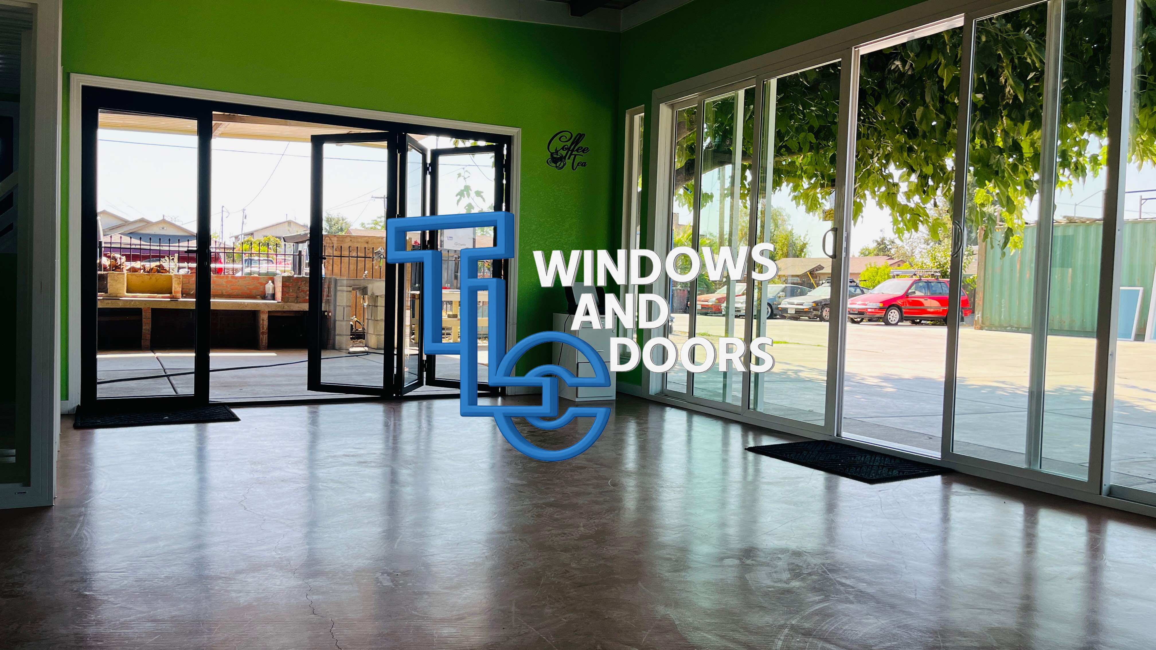 TLC Windows showroom interior featuring large sliding glass doors and windows with company branding
